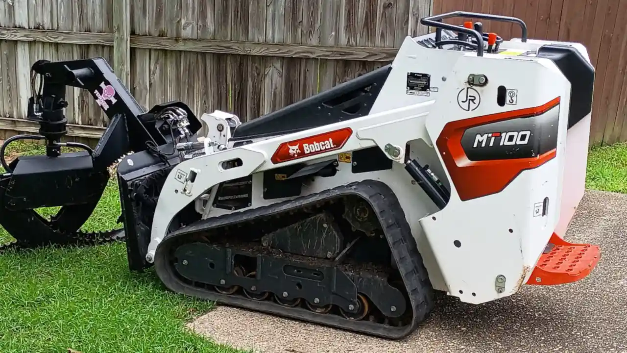The JR Tree Service Bobcat MT100 mini track loader with the JR circle decal on its side, grapple attached